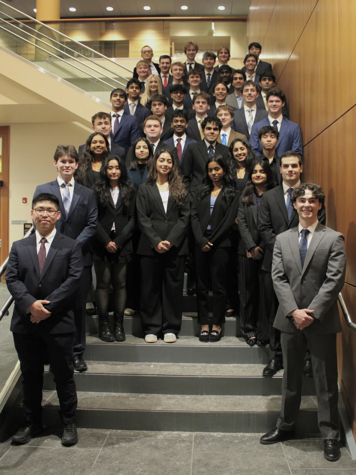 Members of the Purdue Student Managed Investment Fund on the staircase at the Daniels School of Business.